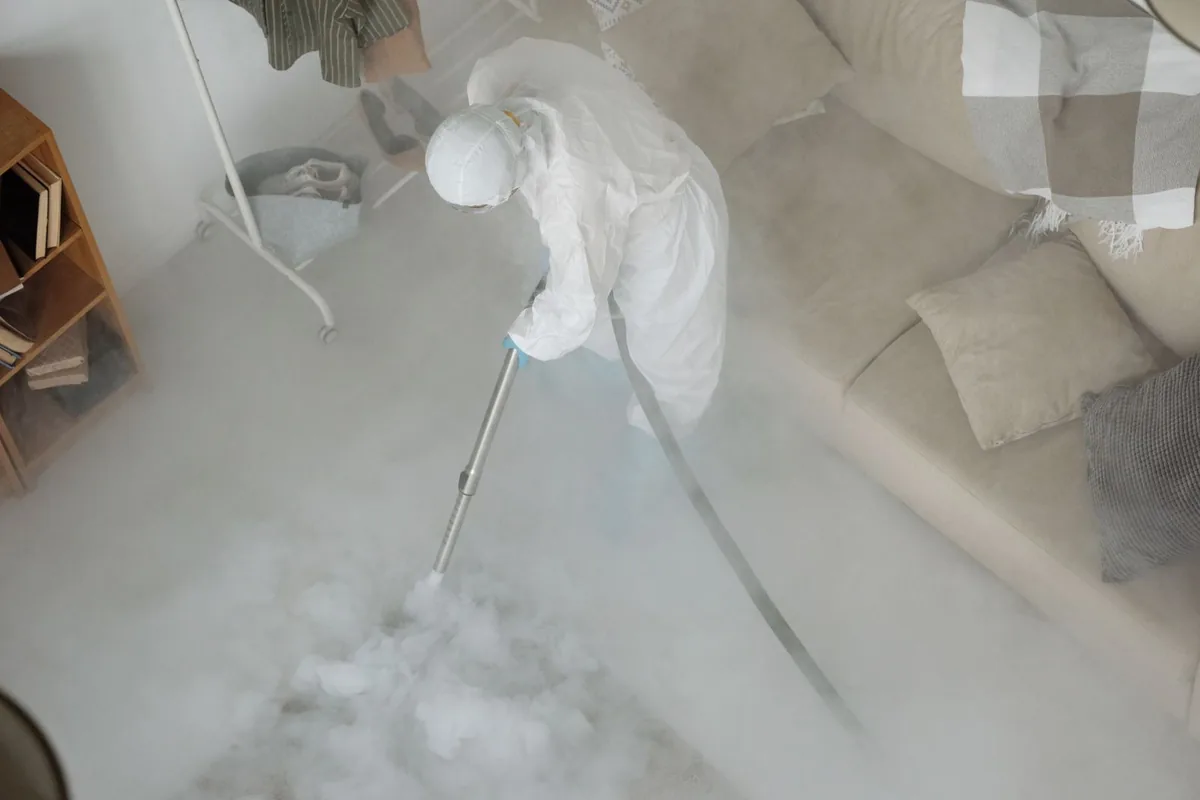 Biohazard cleanup technician in protective equipment, Churchill, MT